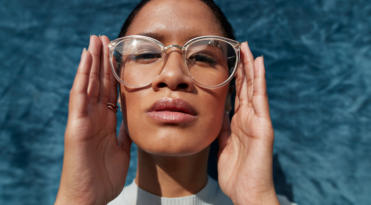 A lady has hold spectacles with two hands