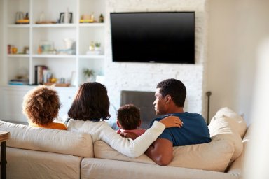 A family sitting on sofa
